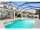 Gorgeous screened pool area with outdoor kitchen, lounge area, and pool with tanning ledge at 242 Milestone Dr, Haines City, FL 33844