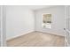 Bright bedroom featuring neutral walls, updated flooring, and ample natural light at 2460 Formax Dr, Orlando, FL 32828