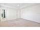 Bright bedroom features neutral carpet, ceiling fan and access to an ensuite bathroom with glass-enclosed shower at 2460 Formax Dr, Orlando, FL 32828