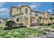 Charming two-story townhome featuring a blue front door, well-maintained landscaping, and a welcoming entrance at 2460 Formax Dr, Orlando, FL 32828