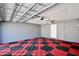 A two-car garage featuring painted walls, ceiling beams, and a tile floor at 2460 Formax Dr, Orlando, FL 32828