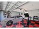 This two-car garage is virtually staged with a car, an exercise bike, and other furnishings at 2460 Formax Dr, Orlando, FL 32828