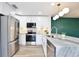 Modern kitchen with stainless steel appliances, white cabinets, and granite countertops at 2460 Formax Dr, Orlando, FL 32828