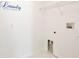 Clean, bright laundry room features white walls, white trim, and hookups for a washer and dryer at 2460 Formax Dr, Orlando, FL 32828