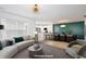 Virtually staged living room with modern furniture, decor, and light wood floors for an inviting atmosphere at 2460 Formax Dr, Orlando, FL 32828