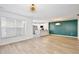 Bright, open-concept living space featuring light wood floors, stairs, and modern lighting fixtures at 2460 Formax Dr, Orlando, FL 32828