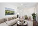 This staged living room features neutral accents, neutral carpet and a chandelier at 2460 Formax Dr, Orlando, FL 32828