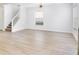 Bright, airy living room with light wood floors and plenty of natural light from a large window at 2460 Formax Dr, Orlando, FL 32828