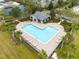 Aerial view of community pool, lounge chairs, poolside building, and palm trees at 2460 Formax Dr, Orlando, FL 32828