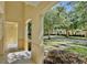 Inviting covered porch showcasing views of the street, manicured landscaping, and neighboring townhomes at 2460 Formax Dr, Orlando, FL 32828