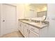 Bathroom featuring dual sinks, granite counters, and white cabinetry at 2524 Harmonia Hammock Rd, Harmony, FL 34773