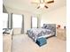 Bedroom with natural light, ceiling fan, and a decorative blue bedspread at 2524 Harmonia Hammock Rd, Harmony, FL 34773