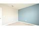 A cozy bedroom with modern blue accent wall and neutral walls at 2524 Harmonia Hammock Rd, Harmony, FL 34773
