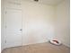 Bedroom with beige carpet features white door and Hello Kitty pet bed at 2524 Harmonia Hammock Rd, Harmony, FL 34773