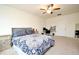 Spacious bedroom with ceiling fan, desk, and two side tables at 2524 Harmonia Hammock Rd, Harmony, FL 34773
