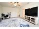 Bedroom featuring desk, bed, large TV and ceiling fan at 2524 Harmonia Hammock Rd, Harmony, FL 34773