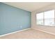 A cozy bedroom with modern blue accent wall and natural light from the window at 2524 Harmonia Hammock Rd, Harmony, FL 34773