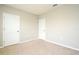 Bedroom with neutral carpet and walls and two white doors at 2524 Harmonia Hammock Rd, Harmony, FL 34773