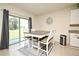 Cozy breakfast nook featuring a modern table, chairs, and sliding glass doors to backyard at 2524 Harmonia Hammock Rd, Harmony, FL 34773