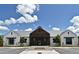 Exterior of community clubhouse with modern farmhouse architecture, ample parking at 2524 Harmonia Hammock Rd, Harmony, FL 34773