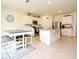 Open kitchen area with white cabinets, granite countertops, stainless appliances, and eat-in nook at 2524 Harmonia Hammock Rd, Harmony, FL 34773