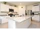 Updated kitchen with white cabinets, granite countertops, stainless steel appliances, and center island at 2524 Harmonia Hammock Rd, Harmony, FL 34773