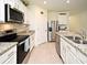 Well-equipped kitchen with stainless steel appliances, granite countertops, and ample cabinet space at 2524 Harmonia Hammock Rd, Harmony, FL 34773