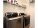 Laundry room featuring front load washer and dryer and wire shelving at 2524 Harmonia Hammock Rd, Harmony, FL 34773