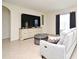Comfortable living room featuring modern furniture, a large TV, and neutral tones at 2524 Harmonia Hammock Rd, Harmony, FL 34773