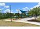 Community playground with swings, slides, and shade structure for neighborhood  at 2524 Harmonia Hammock Rd, Harmony, FL 34773