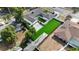 An aerial view showing a well-designed property with lush, green synthetic grass and privacy fencing at 2803 Tech Dr, Orlando, FL 32817