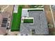 This aerial shows a property featuring a meticulously maintained grey roof and lush synthetic green lawn at 2803 Tech Dr, Orlando, FL 32817