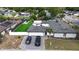 An aerial view of a lovely home with a courtyard, two cars in the driveway, and a green synthetic lawn at 2803 Tech Dr, Orlando, FL 32817