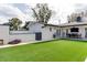 Large backyard with artificial turf, patio, and outdoor dining space at 2803 Tech Dr, Orlando, FL 32817