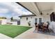 Inviting backyard with manicured lawn, covered patio, and outdoor dining setup at 2803 Tech Dr, Orlando, FL 32817