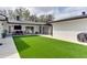 Spacious backyard with artificial turf and patio area for entertaining guests at 2803 Tech Dr, Orlando, FL 32817