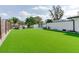 Large backyard featuring green lawn and white brick fence is perfect for entertaining and relaxing at 2803 Tech Dr, Orlando, FL 32817