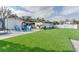 Spacious backyard with artificial turf and stone patio, featuring a trampoline and seating area at 2803 Tech Dr, Orlando, FL 32817