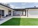 The backyard features a modern outdoor design with concrete patio and green artificial turf at 2803 Tech Dr, Orlando, FL 32817