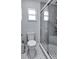 Bathroom featuring a toilet, shower, and small window at 2803 Tech Dr, Orlando, FL 32817