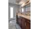 Elegant bathroom with a granite countertop, a wooden framed mirror, and a shower that creates a relaxing space at 2803 Tech Dr, Orlando, FL 32817