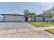 Charming single story home with brick accents, paved driveway, and manicured front lawn at 2803 Tech Dr, Orlando, FL 32817