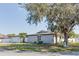 Charming single-story home with well-manicured lawn, mature trees, and updated exterior at 2803 Tech Dr, Orlando, FL 32817