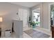 Bright foyer with a white front door, marble floors, and a large window showcasing backyard views at 2803 Tech Dr, Orlando, FL 32817