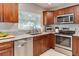Bright kitchen featuring granite countertops, stainless steel appliances, and wood cabinets, perfect for culinary enthusiasts at 2803 Tech Dr, Orlando, FL 32817