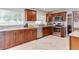 Modern kitchen with stainless steel appliances, granite countertops, and sleek hardwood cabinets at 2803 Tech Dr, Orlando, FL 32817