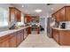 Charming kitchen with wood cabinets, granite countertops, and stainless steel appliances, offering a blend of style and functionality at 2803 Tech Dr, Orlando, FL 32817