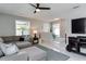 Comfortable living room with modern ceiling fan, plush sectional sofa, and large window at 2803 Tech Dr, Orlando, FL 32817