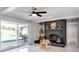 Inviting living room featuring a brick fireplace, and sliding doors that lead to an outdoor patio at 2803 Tech Dr, Orlando, FL 32817