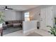 Open living room with marble floors, a comfortable sectional sofa, and a decorative entry door at 2803 Tech Dr, Orlando, FL 32817